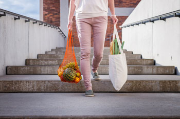 Woman Walks with Reusable Shopping Bags