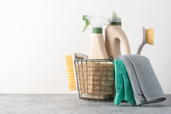 Basket of Cleaning Supplies on Neutral Background
