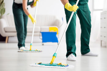 Team of Cleaners Sweep Floor