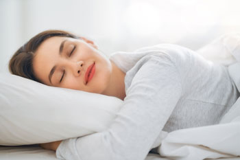 Woman Sleeping in Bright, Clean Room