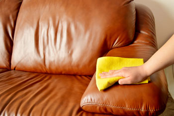 Person Polishing Leather Couch
