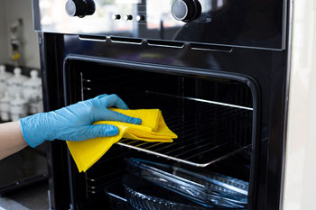 Gloved Hand Cleaning Oven Rack