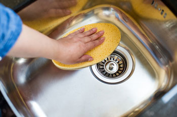 Cleaning Sink with a Sponge