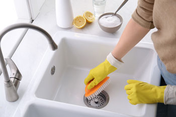 Cleaner scrubs a kitchen sink
