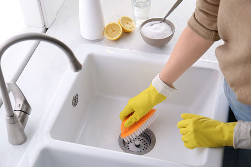 Cleaner Scrubs Porcelain Sink with Brush