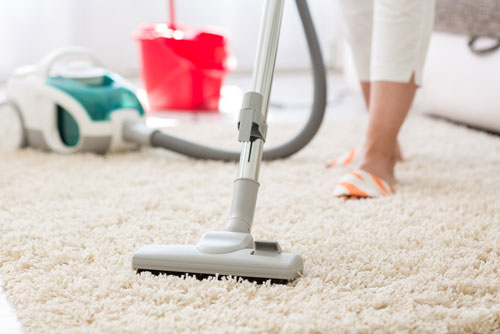 Person Vacuums Carpet