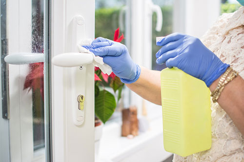 Cleaner Wipes Down Door Handle