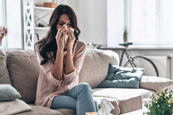 Woman Sneezes from Allergens in her Home